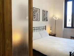 a bedroom with a white bed and a window at RomeAsYouLike - Vatican Apartment N°73 in Rome