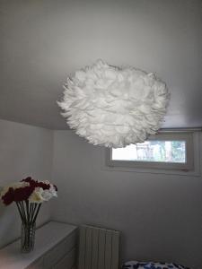 a large white chandelier hanging from a ceiling at Villa Hélène in Créteil