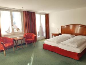 um quarto de hotel com uma cama, uma mesa e cadeiras em Self service Guesthouse Berggeist em Saas-Fee