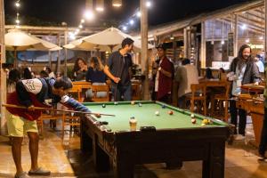 a man playing a game of pool in a bar at Viajero-Kokopelli Paracas Hostel in Paracas
