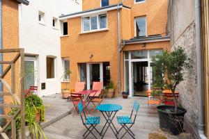 a patio with chairs and a table on a deck at La maison d'Yport in Yport