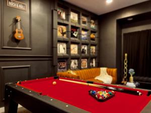 a living room with a pool table and a guitar at Trio Sonata, 3-Bed Rock n Roll Residence in Northern Liberties in Philadelphia