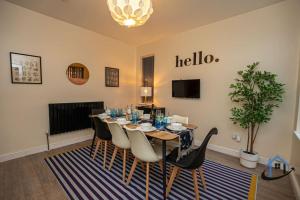a dining room with a table and chairs at Sandby House, King beds workspace corporates parking sleeps 10 in Nottingham