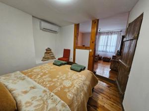 a bedroom with a bed and a chair in it at Guest House GURKO 7 in Veliko Tŭrnovo