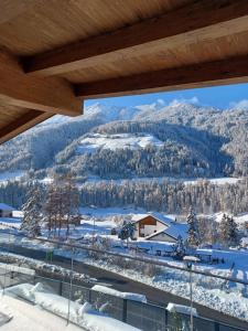 a view of the snow covered mountains from a building at Appartements Zinner-Pale in Fulpmes