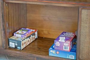 two boxes of wii boxes sitting on a shelf at Revitalizing 3 Bedroom Home With Pool, Pet-Friendly, Wi-fi in Bakersfield