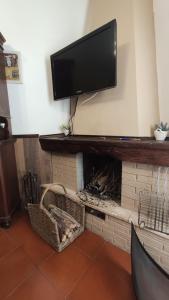 a flat screen tv above a fireplace with a tv on the wall at Casa Martino in Castel di Sangro