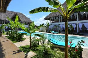 a view of the resort with a pool and palm trees at Rafiki Jua Resort in Watamu