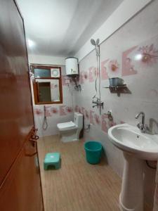 a bathroom with a sink and a toilet at Himalaya View in Rānīkhet +65 photos