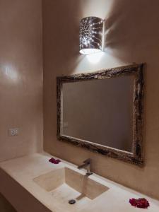 a bathroom with a sink and a mirror at Rafiki Jua Resort in Watamu