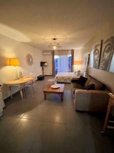 a living room with a couch and a table at Superbe studio 34m2 avec terrasse aperçu mer in Sanary-sur-Mer