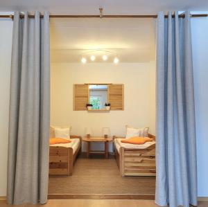 a bedroom with two beds and a window with curtains at Ferienwohnung Pasek in Mehlmeisel
