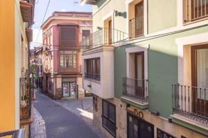 an empty street in an alley between buildings at BaruHaus Cardiles in León +3 photos
