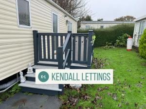a yard with a sign that reads kennel settings at Stoke Clump (Green Lawns) in Selsey