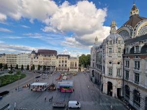 a city square with buildings and a street with cars at Stunning View + Japan Design Bed @ Central Station in Antwerp