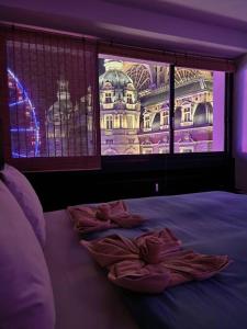 a bedroom with a bed with pink towels on it at Stunning View + Japan Design Bed @ Central Station in Antwerp