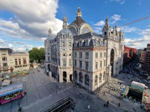 a large white building in a city at Stunning View + Japan Design Bed @ Central Station in Antwerp