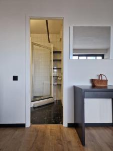 a room with a counter and a hallway with a bathroom at Stunning View + Japan Design Bed @ Central Station in Antwerp