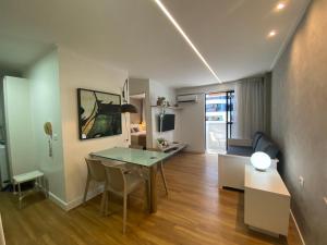 a living room with a table and a dining room at Beira Mar Apartmento 107 in Maceió