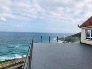 a view of the ocean from a balcony of a house at Casa Playa Arnela in Carballo