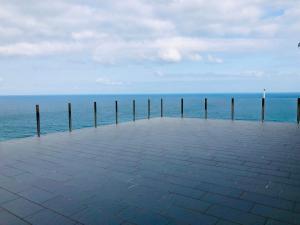 a pier with the ocean in the background at Casa Playa Arnela in Carballo