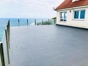 a patio with the ocean in the background at Casa Playa Arnela in Carballo