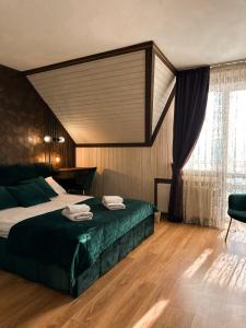 a bedroom with a large bed and a window at Villa Blanc in Bukovel