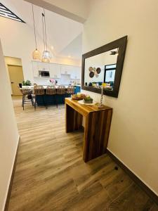 a kitchen and a living room with a table and a mirror at Casa Coral Azul in Cahuita +61 photos