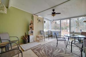 a room with chairs and a table and a kitchen at Tahlequah Duplex with Screened-in Porch and Fire Pit! in Tahlequah