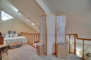 a attic bedroom with a bed and a staircase at Tahlequah Duplex with Screened-in Porch and Fire Pit! in Tahlequah