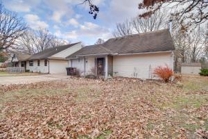 a house with a large pile of leaves in front of it at Tahlequah Duplex with Screened-in Porch and Fire Pit! in Tahlequah