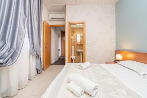 Postel nebo postele na pokoji v ubytování Hotel Donatello