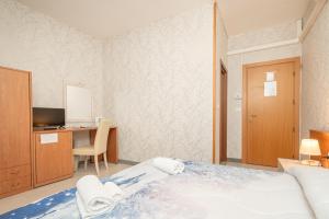 Postel nebo postele na pokoji v ubytování Hotel Donatello