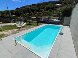 a swimming pool on top of a house at Floripa Glamping in Florianópolis
