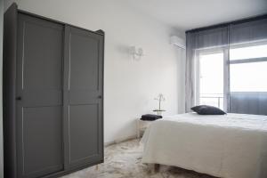 a bedroom with a bed and a large cabinet at Acqua Holiday House in Taranto