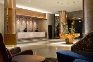 a lobby of a hotel with a reception desk at Hotel Santika Premiere Kota Harapan Indah in Bekasi