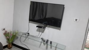 a flat screen tv hanging on a wall at M Pension in Addis Ababa