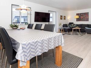 a dining room and living room with a table and chairs at Holiday home Thyborøn VI in Thyborøn