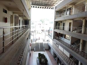 an empty hallway of an apartment building with stairs at Hotel Vraj in Rājpīpla