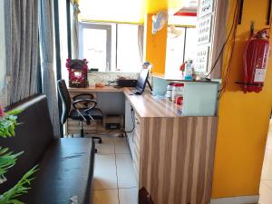 an office with a desk with a laptop on it at Hotel Vraj in Rājpīpla