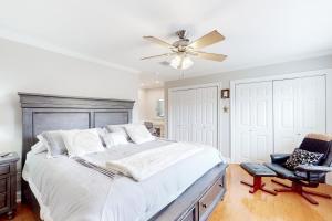 a bedroom with a large bed and a ceiling fan at Lanai Village #181 in Diamondhead +12 photos