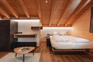 a bedroom with a bed and a wooden ceiling at Ischgl Panorama in Kappl