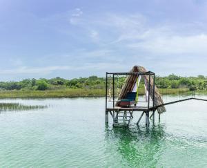 a hammock in the middle of a body of water at Paraíso Nimah in Flores