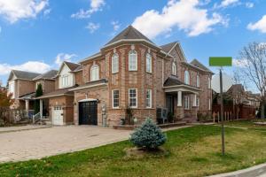 a large brick house with a driveway at 4-BR Family Haven - Near Wonderland and Vaughan Mills in Vaughan