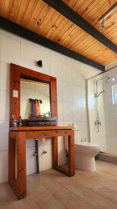 bagno con tavolo in legno, lavandino e vasca di Casa Lomas de Cuchi a Constitución