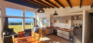 a kitchen and dining room with a table and a dining room at Casa Lomas de Cuchi in Constitución