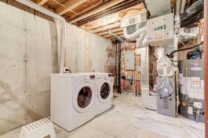 a laundry room with a washing machine in it at Hamilton 3BR Gem - Comfort Stay, City and Nature Mix in Hamilton