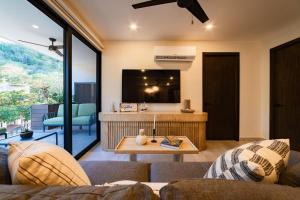 a living room with a couch and a tv at 3018 - Ziba Condo 208 in Santa Cruz Huatulco