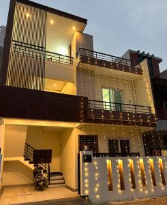 a building with a balcony with lights on it at Spacious Villa in Dehradun in Dehradun