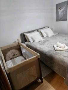 a bed with two pillows and a box at Nektar 88 in Vrnjačka Banja